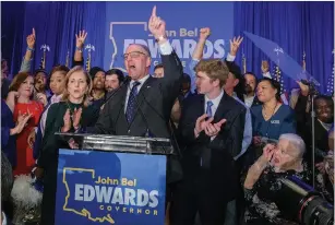  ?? Associated Press ?? ■ Louisiana Gov. John Bel Edwards arrives to address supporters at his election night watch party Saturday in Baton Rouge, La.