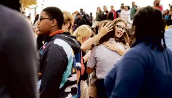  ?? JORDAN OPP/ST. LOUIS POST-DISPATCH VIA ASSOCIATED PRESS ?? People gathered outside Central Visual and Performing Arts High School in St. Louis after the shooting. Seven were injured.