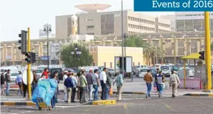  ??  ?? KUWAIT: In this December 7, 2016 photo, migrant workers are seen crossing a street in Kuwait City. — Photo by Yasser Al-Zayyat