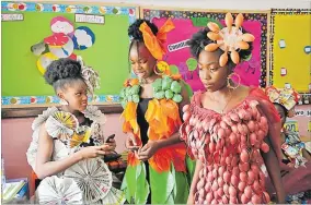  ?? Picture: AP Photo/Sunday Alamba ?? Jalokun Nifemi, left, wears an outfit made from newspapers, Okpala Crystal, centre, wears an outfit made from recycled plastic
bags and Nathaniel Edegwa, right, wears an outfit made from recycled plastic spoons, wait back stage before a “trashion show”
in Sangotedo Lagos, Nigeria, Saturday last week.