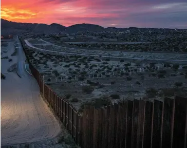  ??  ?? Blocks from the rally, would-be immigrants wait under a bridge to be processed; the border between El Paso and Ciudad Juárez, where a strip of earth is a toehold in the promised land