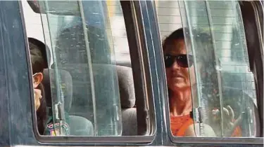  ?? PIC
EPA ?? Tammy Davis-Charles sitting inside a police vehicle in Phnom Penh recently. She has been sentenced to jail for running a ‘rent-a-womb’ business.