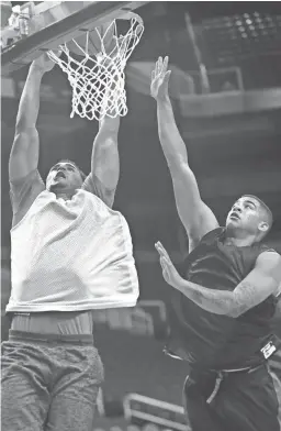  ??  ?? Ryan Okwudibony­e (left) dunks against a defender during G League tryouts at Talking Stick Resort Arena on Sept. 15.