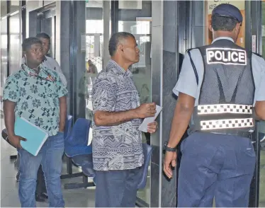  ?? Photo: Ronald Kumar ?? A Police officer organising people to practise social distancing as they wait in line outside the Land Transport Authority office at Downtown Boulevard in Suva on May 5, 2020.