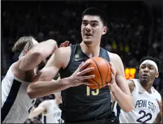  ?? MICHAEL CONROY — THE ASSOCIATED PRESS ?? Purdue center Zach Edey goes up for a shot around Penn State forward Michael Henn, left, during the second half on Wednesday in West Lafayette, Ind. Purdue defeated Penn State 80-60.