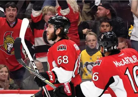  ?? MINAS PANAGIOTAK­IS/GETTY IMAGES ?? Mike Hoffman starts the celebratio­n after scoring the Game 6 winner for the Senators over the Penguins on Tuesday night in Ottawa.