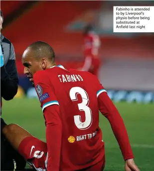  ??  ?? Fabinho is attended to by Liverpool’s physio before being substitute­d at Anfield last night