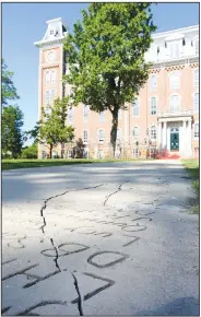  ?? NWA Democrat-Gazette/DAVID GOTTSCHALK ?? Cracks are visible in this section of the Senior Walk outside Old Main on the University of Arkansas, Fayettevil­le, campus. A plan to replace crumbling concrete sections of the sidewalk received a $150,000 boost from a state grant approved earlier this month, but no start date has been set for the project.