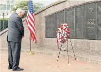  ?? AP ?? US Secretary of State Rex Tillerson bows his head after laying a wreath at Memorial Park in Nairobi to honour the victims of the 1998 US Embassy bombing in March 2018.