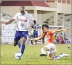  ?? SRENG MENG SRUN ?? Boeung Ket midfielder Esoh Amogba (left) runs with the ball on Saturday during his team’s match against the Ministry of National Defence.