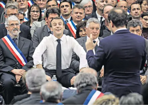  ??  ?? President Emmanuel Macron smiles as he listens to grievances during a meeting attended by 600 local mayors. The debates are a response to the weeks of ‘yellow vest’ protests