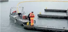  ?? DAVE JOHNSON/WELLAND TRIBUNE ?? A yellow boom is stretched across the Welland Canal south of Bridge 21 Wednesday in Port Colborne.