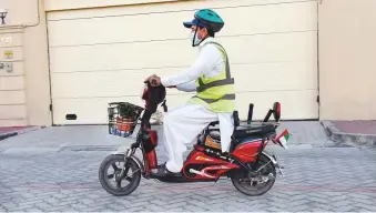  ?? Photos: Virendra Saklani/Gulf News ?? Gardener Sher Alam Khan rides his electric motorbike to work.
