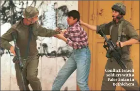  ?? ?? Conflict: Israeli soldiers with a Palestinia­n in Bethlehem