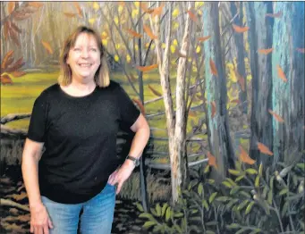  ?? SUSAN DEGRANE/DAILY SOUTHTOWN ?? Elaine Miller stands next to a canvas painting of the Dan RyanWoods in fall. It will be displayed at the Beverly Arts Center starting Friday.