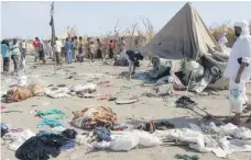  ??  ?? Clothing and belongings were scattered as people tried to flee the temporary camp for the displaced as it was shelled Wam