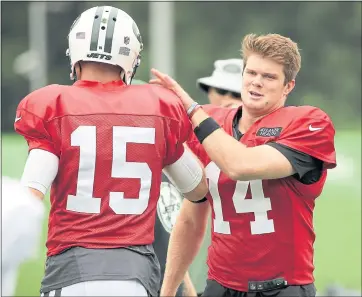  ??  ?? New York Jets’ quarterbac­k Sam Darnold, right, greets quarterbac­k Josh McCown during a practice at the NFL football team’s training camp in Florham Park, N.J., Monday, July 30, 2018. (AP Photo/Seth Wenig)