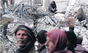  ?? AFP ?? Syrian civilians search for survivors at the site of reported air strikes by regime forces in the rebel-held area of Douma, east of the capital Damascus, Syria, on Feb 9. More than 210,000 people have been killed in Syria since the beginning of the...