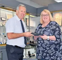  ??  ?? Thrilled: Purdeys Jewellers Manager Russell Wilson presents competitio­n winner Molly Craig with a new Ouzo watch.