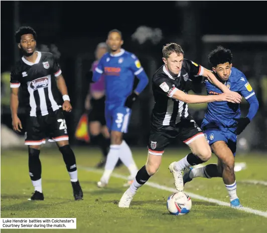  ??  ?? Luke Hendrie battles with Colchester’s Courtney Senior during the match.