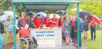  ??  ?? Dannevirke Host Lions with Tararua Mayor Tracey Collis after the official opening of the Domain barbecue in wet weather.