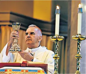  ??  ?? O’brien celebratin­g Mass in 2007 and (below) unveiling a Papal visit tartan outside the Scottish Parliament in 2010