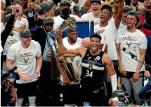  ?? AP ?? Milwaukee turned out in huge numbers to celebrate the success of their beloved Bucks. Left: Bucks forward Giannis Antetokoun­mpo said the NBA title vindicated his decision to stay with the team.