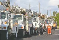  ?? THE ASSOCIATED PRESS ?? Power trucks and workers head out Tuesday from Derby Lane, in St. Petersburg, Fla., into Pinellas County to restore power after Hurricane Irma.