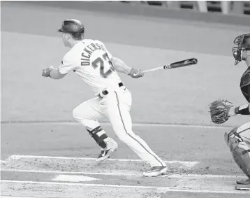  ?? GASTON DE CARDENAS/AP ?? Marlins’ Corey Dickerson singles to center field during the first inning of Game 1 on Sunday.