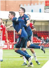  ??  ?? Lafferty (left) celebrates his goal.