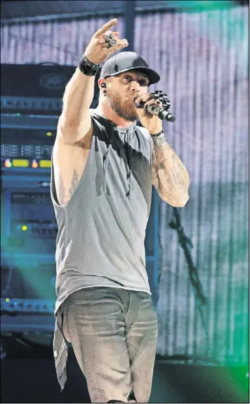  ?? FOR AMERICAN-STATESMAN SUZANNE CORDEIRO ?? Singer Brantley Gilbert, onstage during the 2017 iHeartCoun­try Festival in May, gets near his Jefferson hometown with an Atlanta area concert in early July.