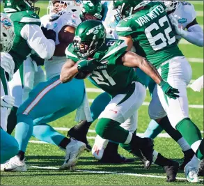  ?? Corey Sipkin / Associated Press ?? The Jets’ Frank Gore runs the ball against the Dolphins last week.