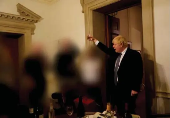  ?? © ?? Een van de foto’s van feestjes waarop Boris Johnson te zien is, met een glas in de hand. Op de voorgrond: nog meer alcohol.
Sue Gray report/reuters