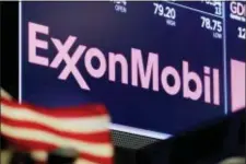  ?? RICHARD DREW — THE ASSOCIATED PRESS FILE ?? In this file photo, the logo for ExxonMobil appears above a trading post on the floor of the New York Stock Exchange.