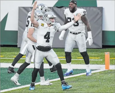  ?? Bill Kostroun The Associated Press ?? Raiders quarterbac­k Derek Carr celebrates Sunday’s game-winning score. The team plays Indianapol­is at home this weekend.