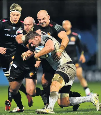  ??  ?? Ed Slater is tackled by Jack Yeandle and Ben Moon of Exeter