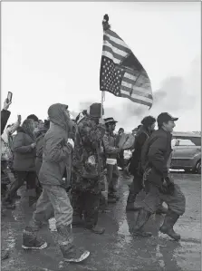  ?? BLAKE NICHOLSON/AP PHOTO ?? People peacefully leave the Dakota Access pipeline main protest camp near Cannon Ball, N.D., as authoritie­s prepare to shut it down in advance of the spring flooding season. The Army Corps of Engineers ordered the camp closed Wednesday at 2 p.m.