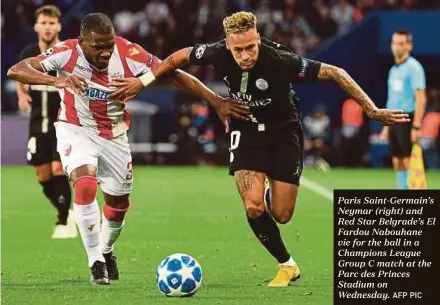  ?? AFP PIC ?? Paris Saint-Germain’s Neymar (right) and Red Star Belgrade’s El Fardou Nabouhane vie for the ball in a Champions League Group C match at the Parc des Princes Stadium on Wednesday.