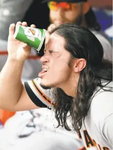  ?? Mitchell Layton / Getty Images ?? Giants starting pitcher Dereck Rodriguez cools off in the dugout at Nationals Park. His father once played for the Nats.