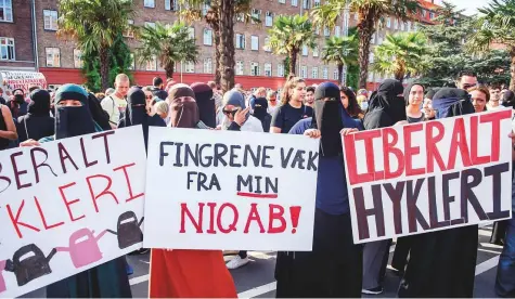  ?? Reuters ?? Women participat­e in a demonstrat­ion on the first day of the implementa­tion of the Danish face veil ban in Copenhagen, Denmark, on Wednesday. Protesters called the new law oppressive and Islamophob­ic.