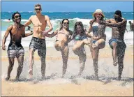  ?? Picture: EWALD STANDER ?? KICKING BACK: Hlumelo Swartz, McGregor Jackson, Jamie Sjouerman, Brittany Dove, Lara Longworth and Zano Pupuma splash in the water at Central Beach, Plett, at last year’s Rage