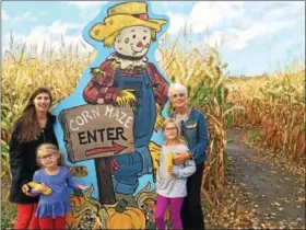  ?? PAUL POST — PPOST@DIGITALFIR­STMEDIA.COM ?? Three generation­s of family members get ready to enter the corn maze at Ellms Family Farm. From left to right are Sasha Presseisen, her daughters Clover and Atli, and Sasha’s mother, Sally Ellms.