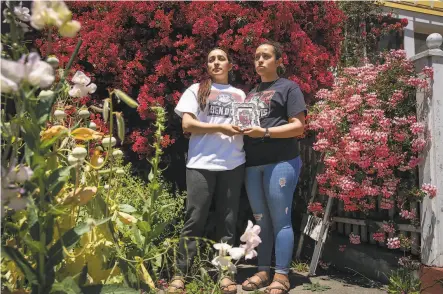  ?? Santiago Mejia / The Chronicle ?? Sisters Michelle (left) and Ashley Monterrosa hold a portrait of their brother Sean, 22, who was fatally shot by Vallejo police.