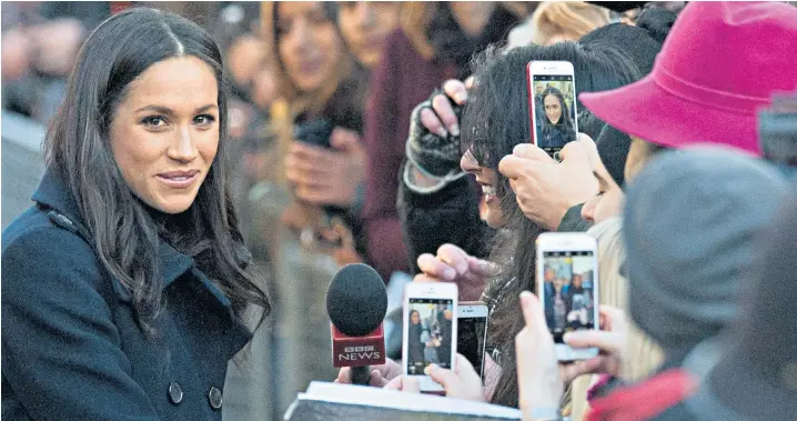  ??  ?? Meghan Markle, accompanyi­ng Prince Harry on an official visit for the first time, meets the public en route to visiting the Terrence Higgins Trust World Aids Day charity fair at the Contempora­ry Centre. The couple went on to see a stage show that...