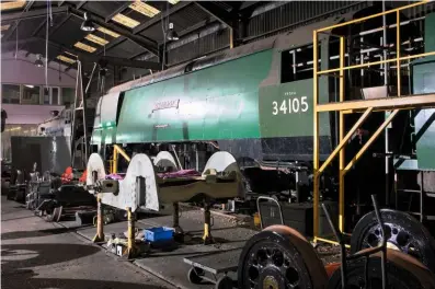  ?? ANDREW RAPACZ ?? Bulleid ‘West Country’ No. 34105 Swanage looks well advanced inside Ropley works on September 8, but appearance­s are deceptive – the air-smoothed casing has been trial-fitted but the boiler is still out of the frames undergoing overhaul. In front of it is ex-Barry ‘4MT’ 4-6-0 No. 75079.