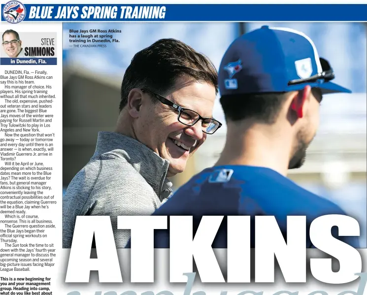  ?? — THE CANADIAN PRESS ?? Blue Jays GM Ross Atkins has a laugh at spring training in Dunedin, Fla.