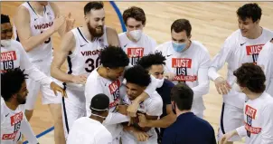  ?? Tribune News Service ?? Reece Beekman #2 of the Virginia Cavaliers reacts with his team after hitting the game-winning threepoint basket as time expired on the clock during the second half of their quarterfin­als game against the Syracuse Orange in the ACC Men’s Basketball Tournament at Greensboro Coliseum on March 11, 2021, in Greensboro, North Carolina.