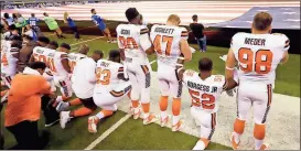  ?? File, Michael Conroy / Standard Journal ?? Several Cleveland Browns players kneel as the national anthem is played during a game against the Colts of Indianapol­is.