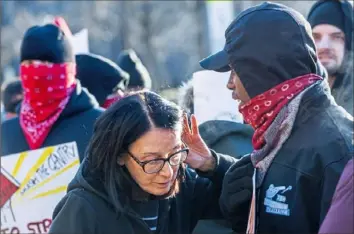  ??  ?? Eileen Kraus-Dobratz of Friendship listens to Saeed Anglin of Lincoln-Lemington explain why he is protesting the plan for the old Penn Plaza site.