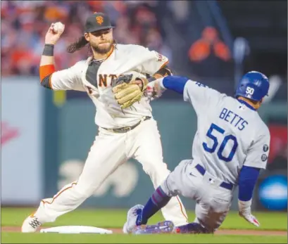  ?? Tribune News Service/bay Area News Group ?? Giants’ Brandon Crawford retires the Los Angeles Dodgers’ Mookie Betts on a fielder’s choice in the first inning of Game 1 of the National League Division Series at Oracle Park in San Francisco Oct. 8.